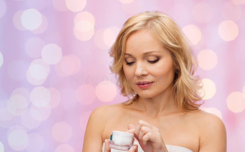 Middle aged woman with cream jar stock photography Middle aged woman with cream jar stock photography