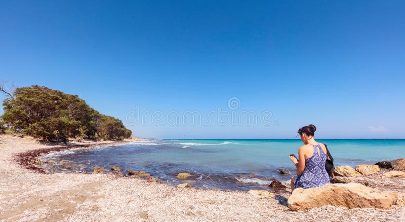 Middle-aged woman with mobile phone on the Mediterranean coast. stock photos Middle-aged woman with mobile phone on the Mediterranean coast. stock photos