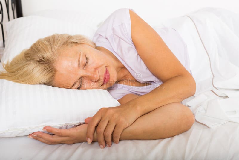 Middle-aged woman sleeping in bed royalty free stock photos Middle-aged woman sleeping in bed royalty free stock photos