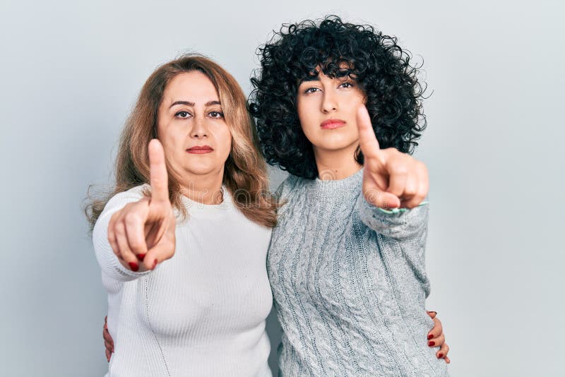 Middle East Mother and Daughter Wearing Casual Clothes Pointing with