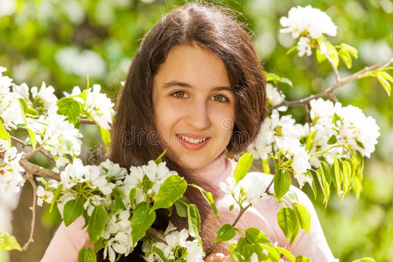 Middle East teenager girl with white pear flowers stock images Middle East teenager girl with white pear flowers stock images