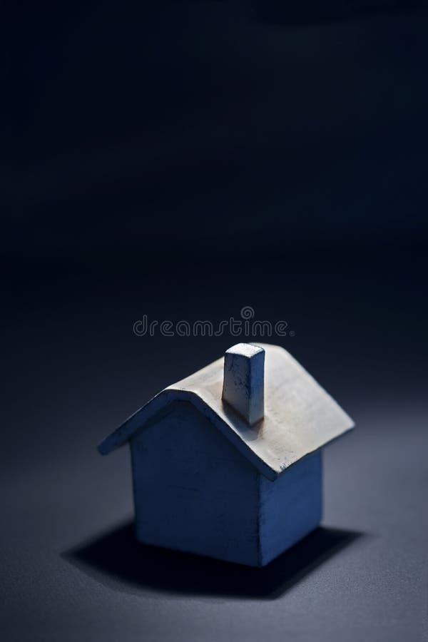 Toy house in blue light, looks like midnight. Closeup. Good real estate, insurance, investment, banking, security issues metaphor. Toy house in blue light, looks like midnight. Closeup. Good real estate, insurance, investment, banking, security issues metaphor.