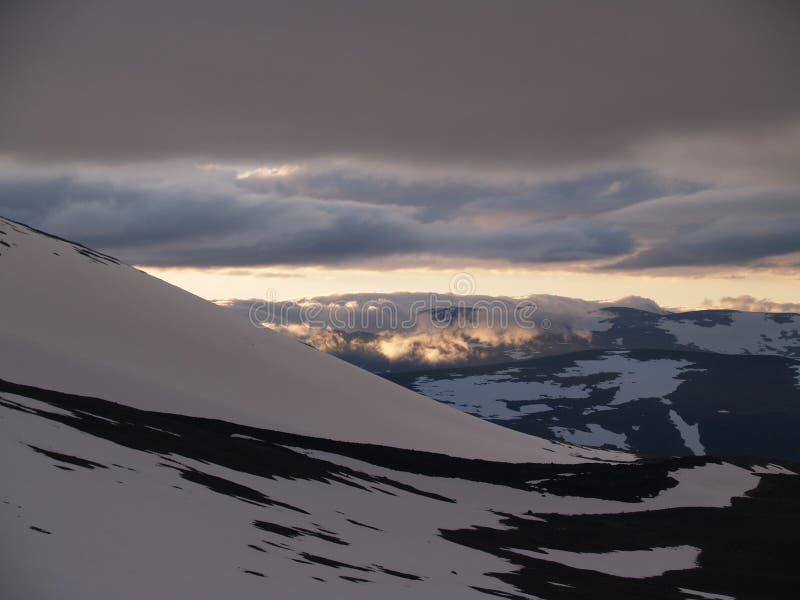 Midnight sun over the snowy mountains