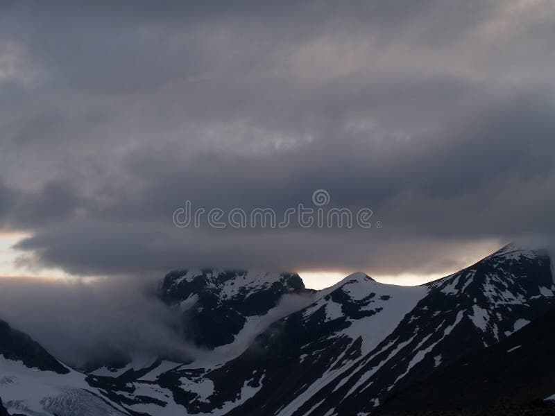 Midnight sun over the snowy mountains