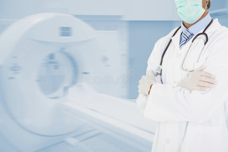 Midsection of doctor standing by CT scanner in hospital stock photography Midsection of doctor standing by CT scanner in hospital stock photography