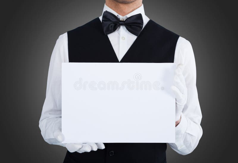 Midsection of waiter holding blank billboard over gray background. Midsection of waiter holding blank billboard over gray background