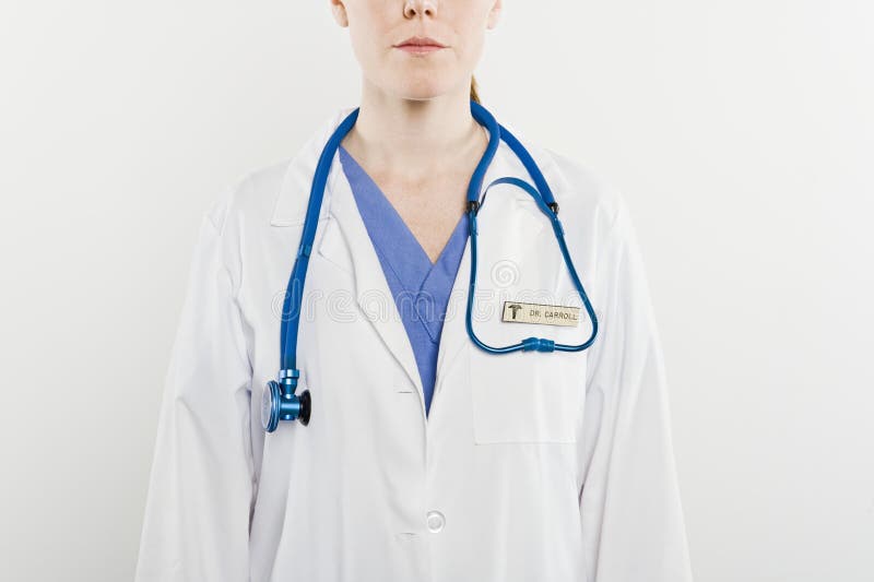 Midsection of a female doctor with stethoscope around neck isolated over white background. Midsection of a female doctor with stethoscope around neck isolated over white background