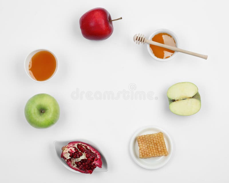 Honey, apples and pomegranate on white background, top view with space for text. Rosh Hashanah holiday. Honey, apples and pomegranate on white background, top view with space for text. Rosh Hashanah holiday