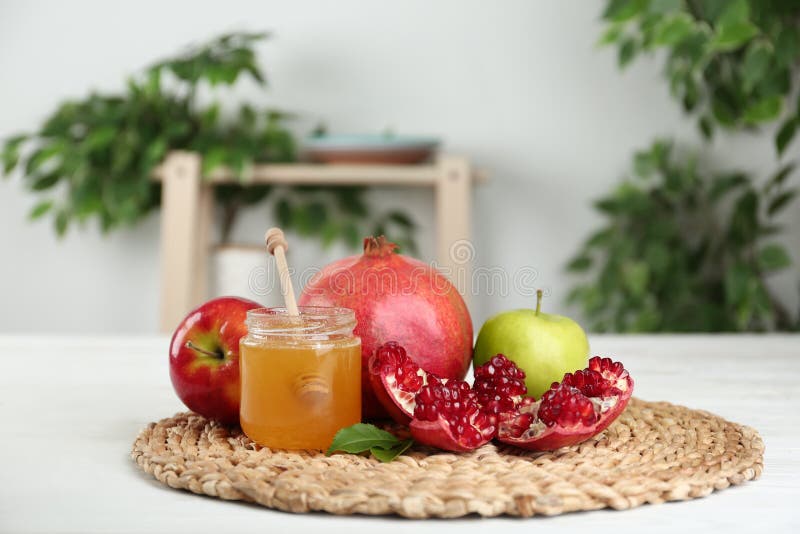 Honey, apples and pomegranate on white wooden table. Honey, apples and pomegranate on white wooden table