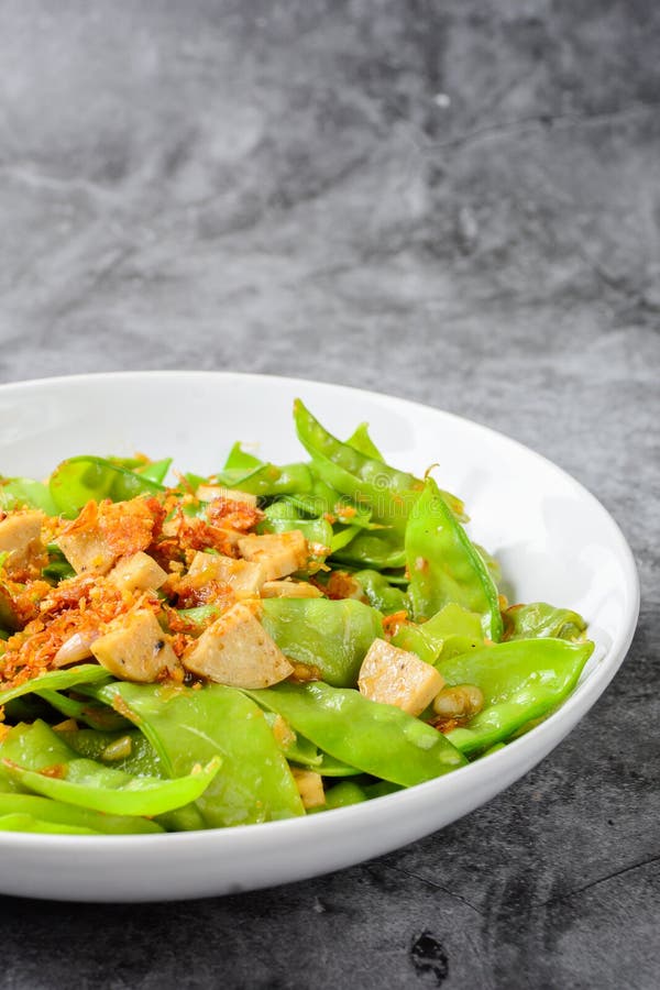 Mieszać Fry Snow Peas z wietnamską grillowaną kiełbasą wieprzową, posypywać chrupiącymi, smażonymi szalotkami i garlikami obraz royalty free Mieszać Fry Snow Peas z wietnamską grillowaną kiełbasą wieprzową, posypywać chrupiącymi, smażonymi szalotkami i garlikami obraz royalty free