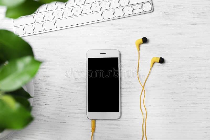 Mieszkanie nieatutowy skład z hełmofonami, smartphone i komputerową klawiaturą na białym drewnianym tle, zdjęcia royalty free Mieszkanie nieatutowy skład z hełmofonami, smartphone i komputerową klawiaturą na białym drewnianym tle, zdjęcia royalty free