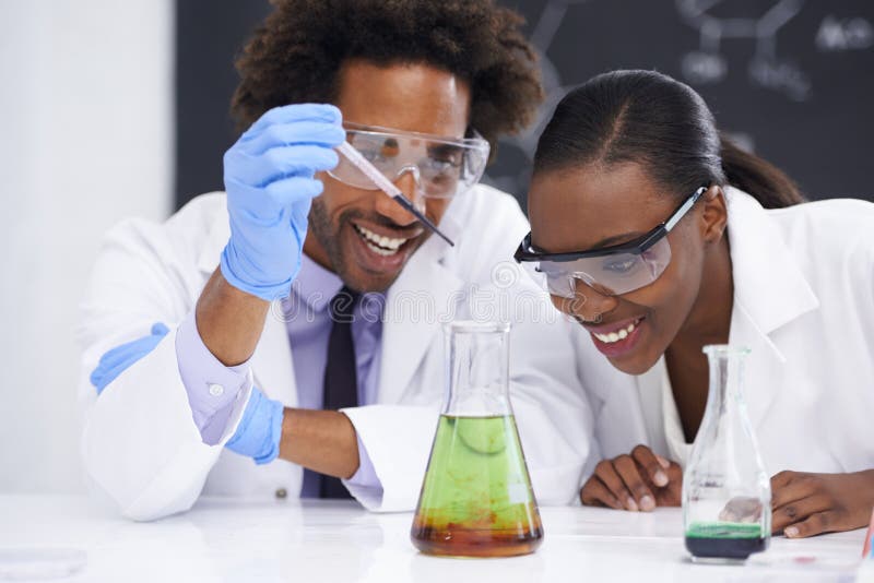 This might be the breakthrough weve been looking for. two scientists conducting an experiment with various chemicals. stock photo
