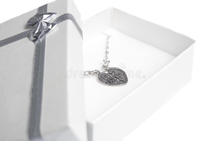 Small gift box with locket saying Best friends. Small gift box with locket saying Best friends.