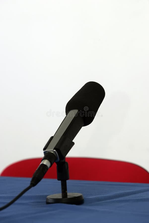 A mic pointing towards viewer on some table. A mic pointing towards viewer on some table