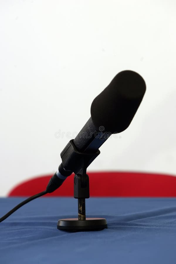 A mic pointing towards viewer on some table. A mic pointing towards viewer on some table