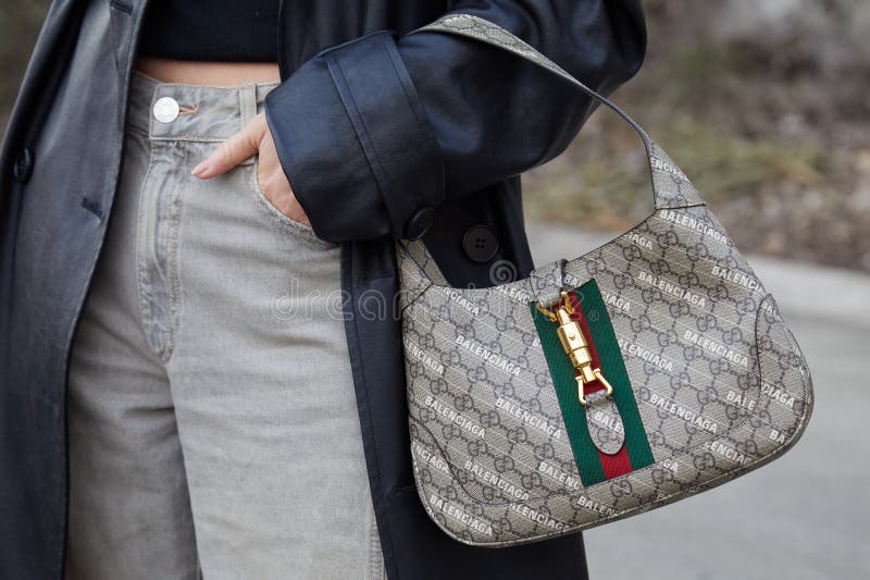 Woman with Gucci red leather bag before Max Mara fashion show