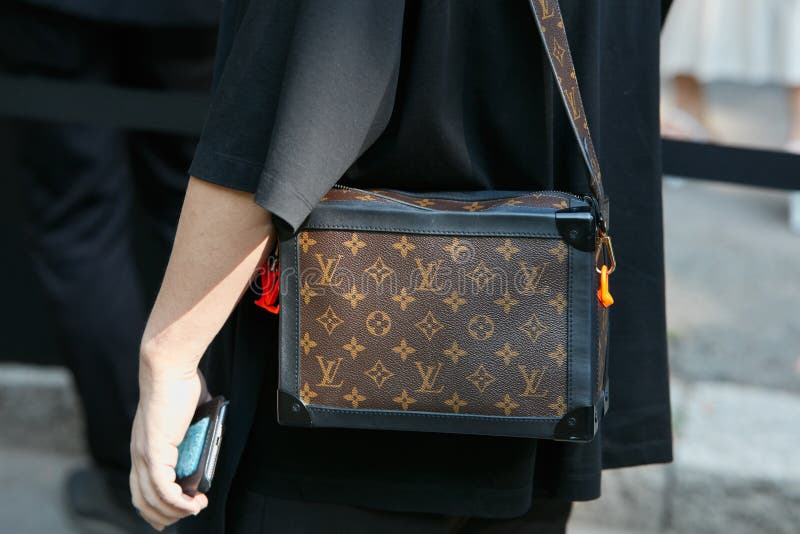 MILAN - JUNE 18: Man with Louis Vuitton brown backpack before