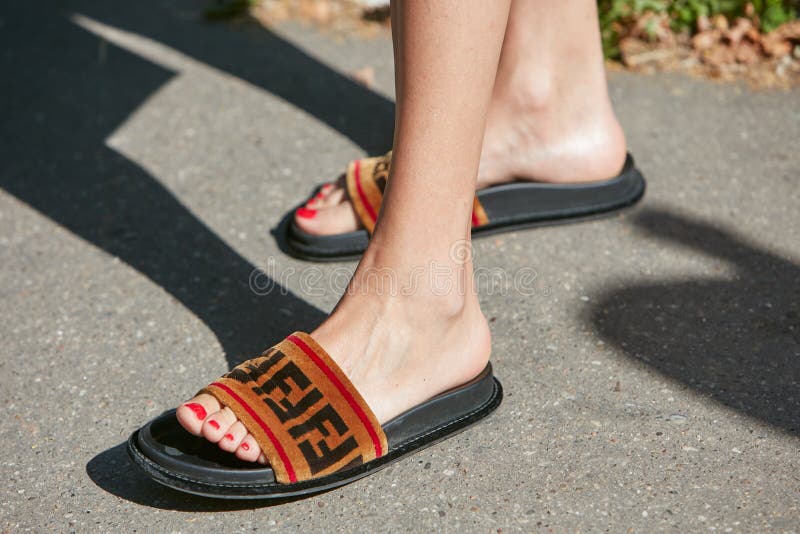 Woman with Fendi slippers and red nail polish before Fendi fashion show, Milan Fashion Week street