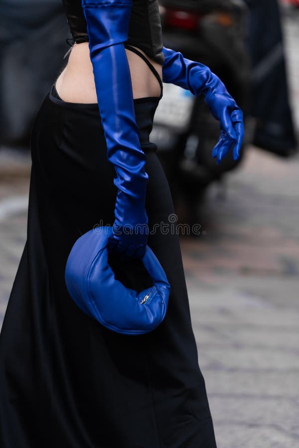 Milan, Italy - September, 21, 2022: Street style outfit details, woman wearing black long skirt, corset, blue leather