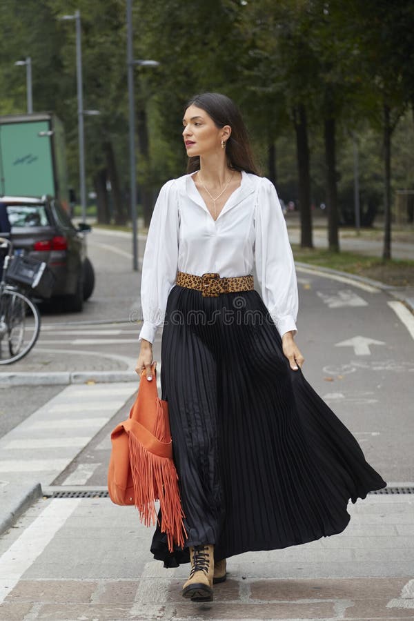 Woman with orange jacket and Balenciaga bag and man with Gucci bag before  John Richmond fashion show, Milan Fashion Week street style – Stock  Editorial Photo © AndreaA. #272373476