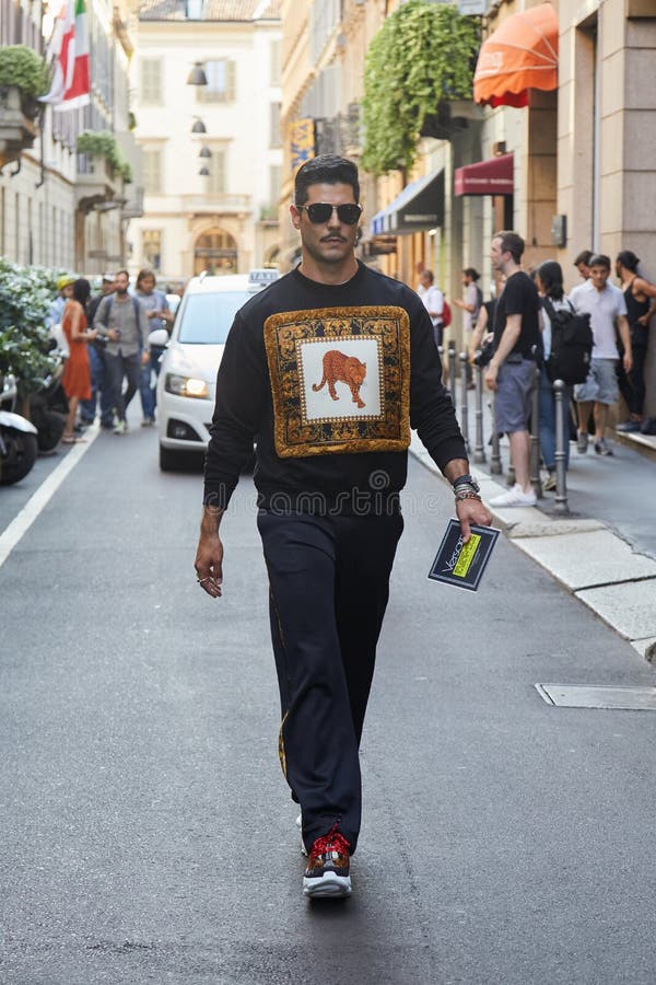 Man and Woman with Versace Clothing with Golden Designs before