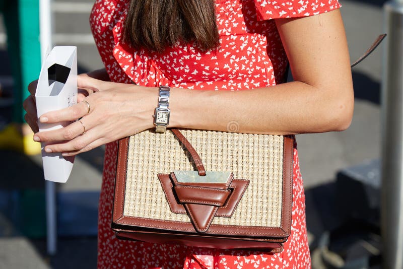 Woman with Cartier watch and Loewe bag before Prada fashion show, Milan Fashion Week street style on June 18