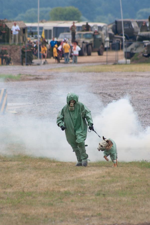 Militaire manager met hond in de uitrusting van de gasdefensie stock foto's Militaire manager met hond in de uitrusting van de gasdefensie stock foto's