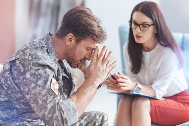 Militar emocionalmente arruinado que intenta conseguir encendido con vida foto de archivo Militar emocionalmente arruinado que intenta conseguir encendido con vida foto de archivo
