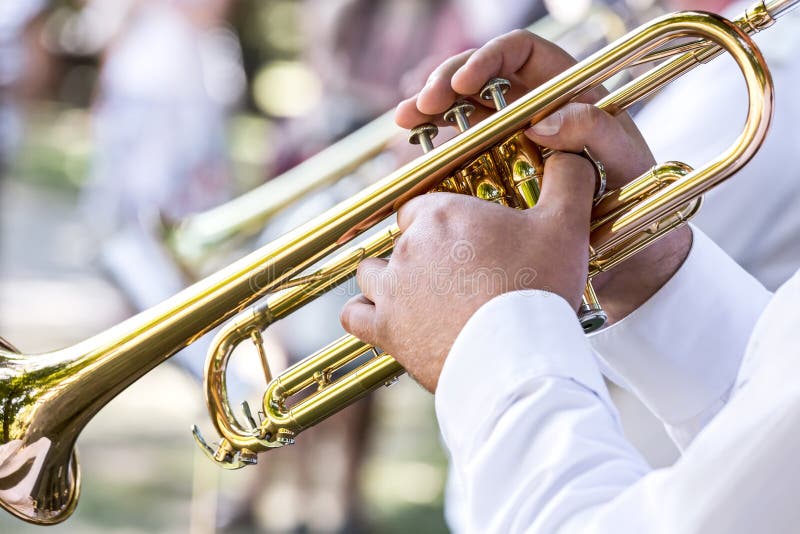 Military musicians playing on trumpets in army brass orchestra. Military musicians playing on trumpets in army brass orchestra