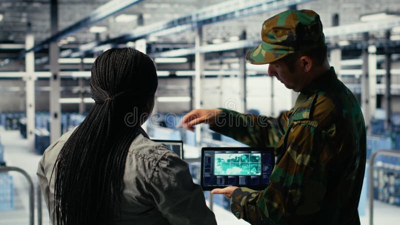Military commander and female programmer in data center tracking coordinates stock video footage