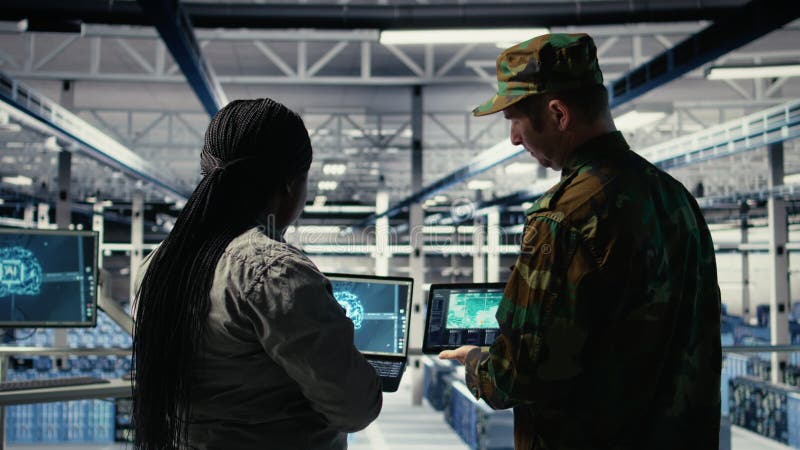Military commander and female programmer in data center tracking coordinates stock footage