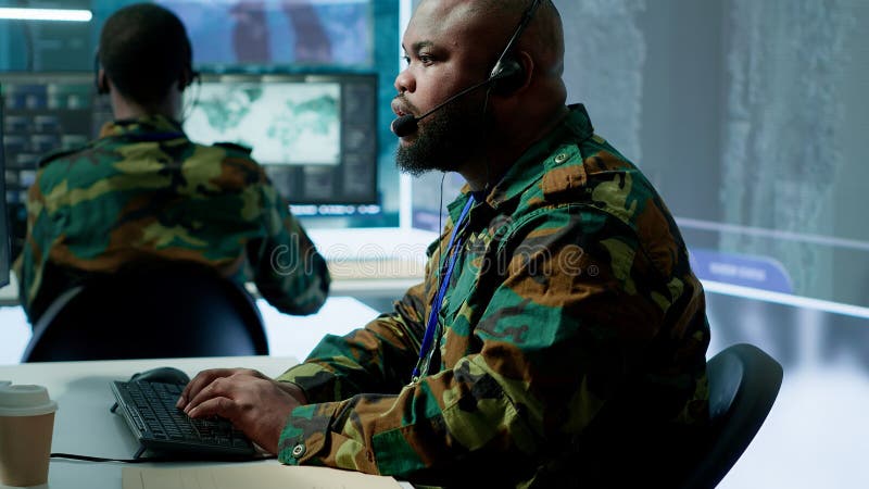Military control room features army personnel monitoring surveillance systems royalty free stock photos