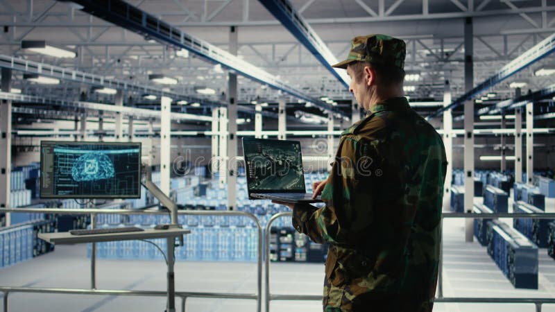Military engineer in data center tracking satellite coordinates using laptop stock footage