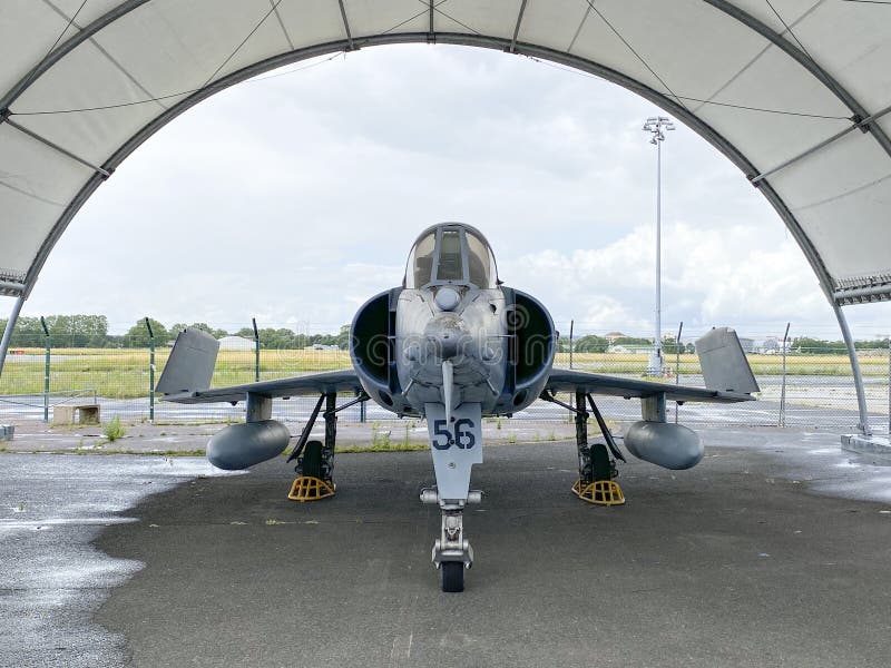 Military fighter jet in a hangar outside