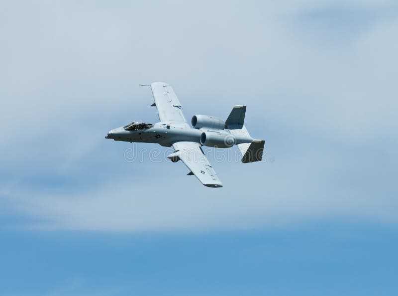 Military A-10 Jet slightly banked comming around making a turn in clear skies. Military A-10 Jet slightly banked comming around making a turn in clear skies