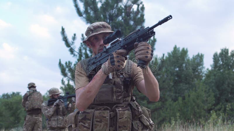 Military troop sitting and aiming