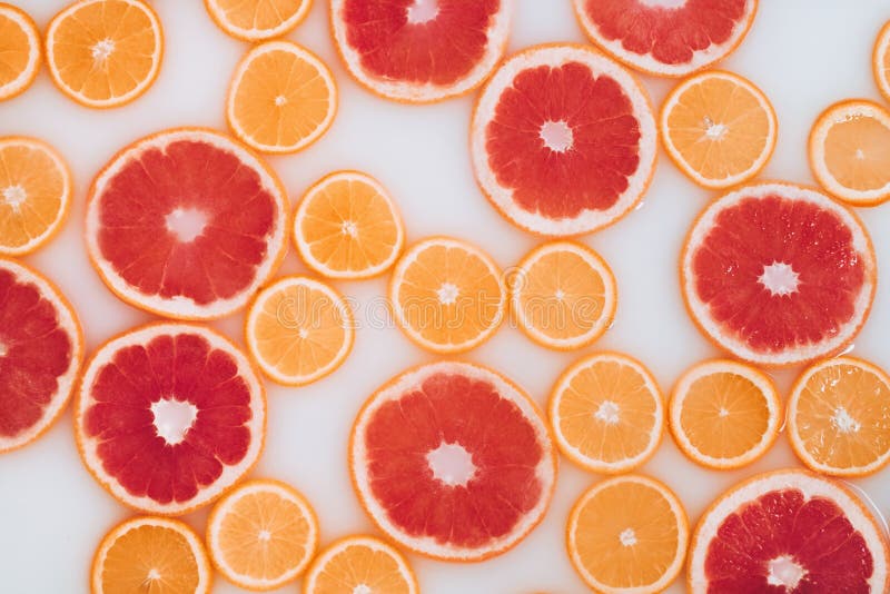 Milk Bath with Grapefruit and Oranges Slices. Top View. Flat Lay Stock