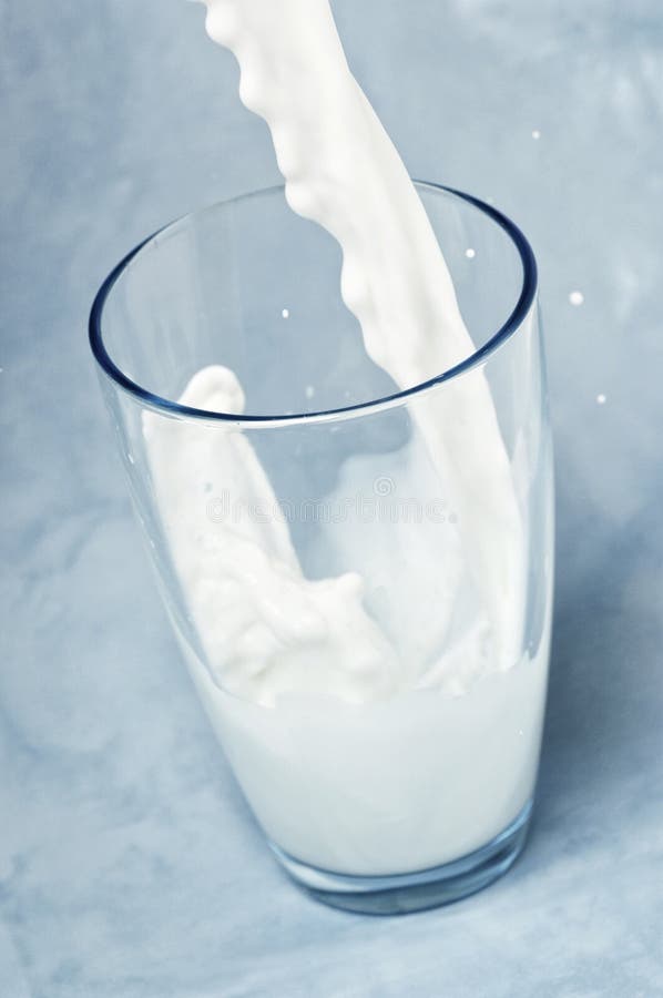 Milk Being Poured into a Glass Stock Photo Image of splashing