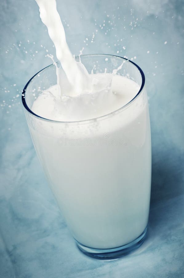 Milk Being Poured into a Glass Stock Photo Image of splashing