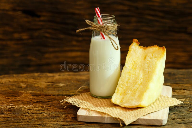 Milk and bread on wood plate and wood background