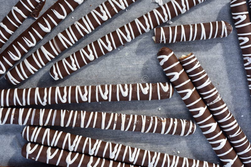 Milk Chocolate Covered Pretzel Sticks with White Chocolate Stripes