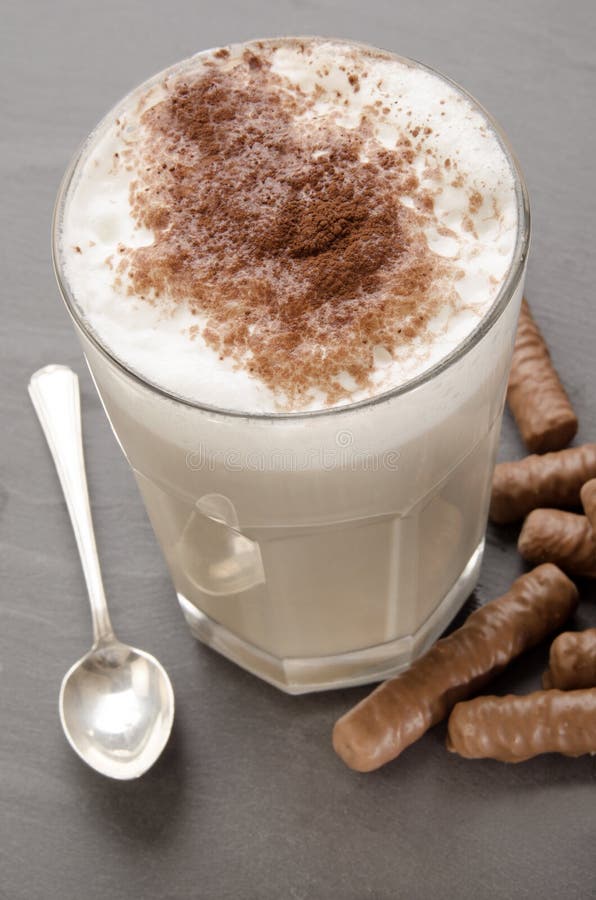 Milk coffee with cocoa powder in a glass