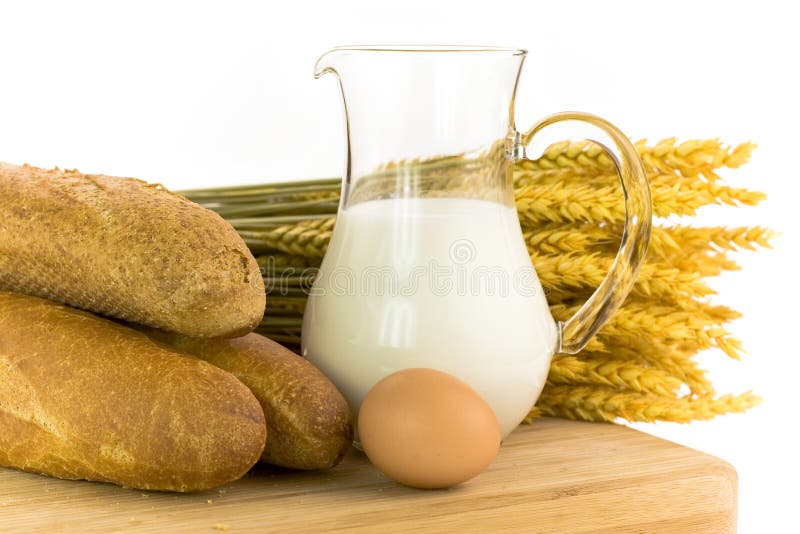 Milk, egg, bread and grain on white background