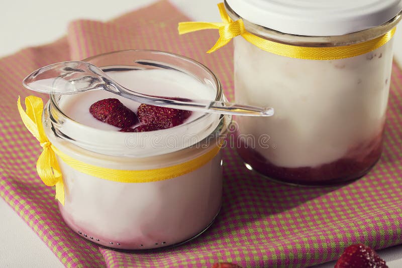 Milk and Fruits. Yogurt from Natural Milk and Strawberries. Spoon Lying