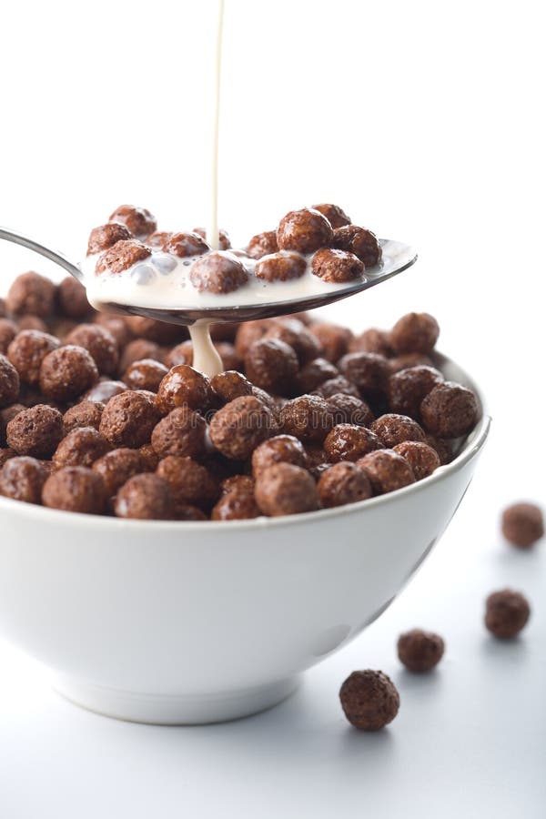 Milk pouring into bowl with chocolate balls