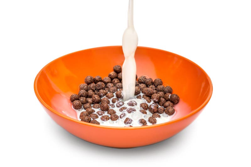 Milk Pouring into the Bowl with Chocolate Cereal Balls on White
