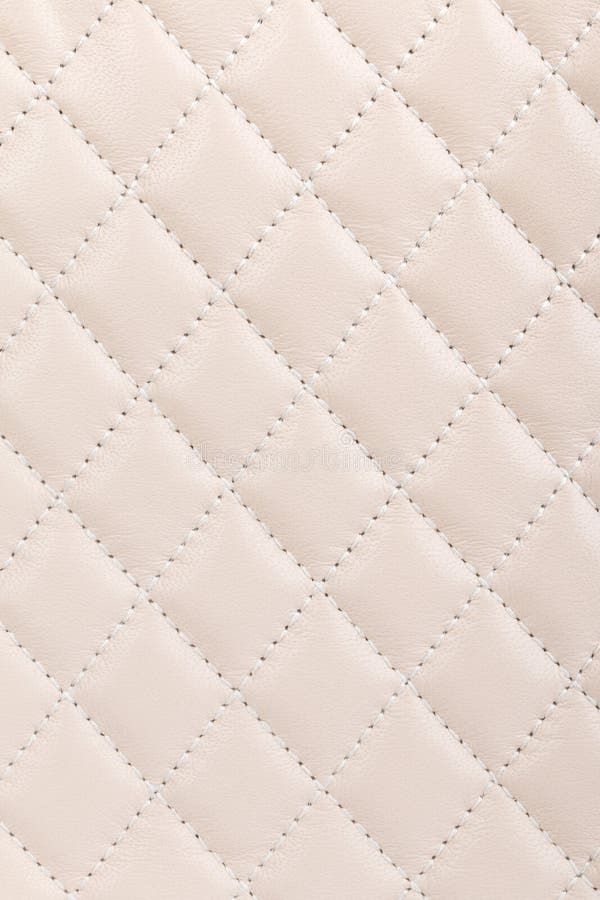 Milky white quilted leather closeup background. Milky white quilted leather closeup background