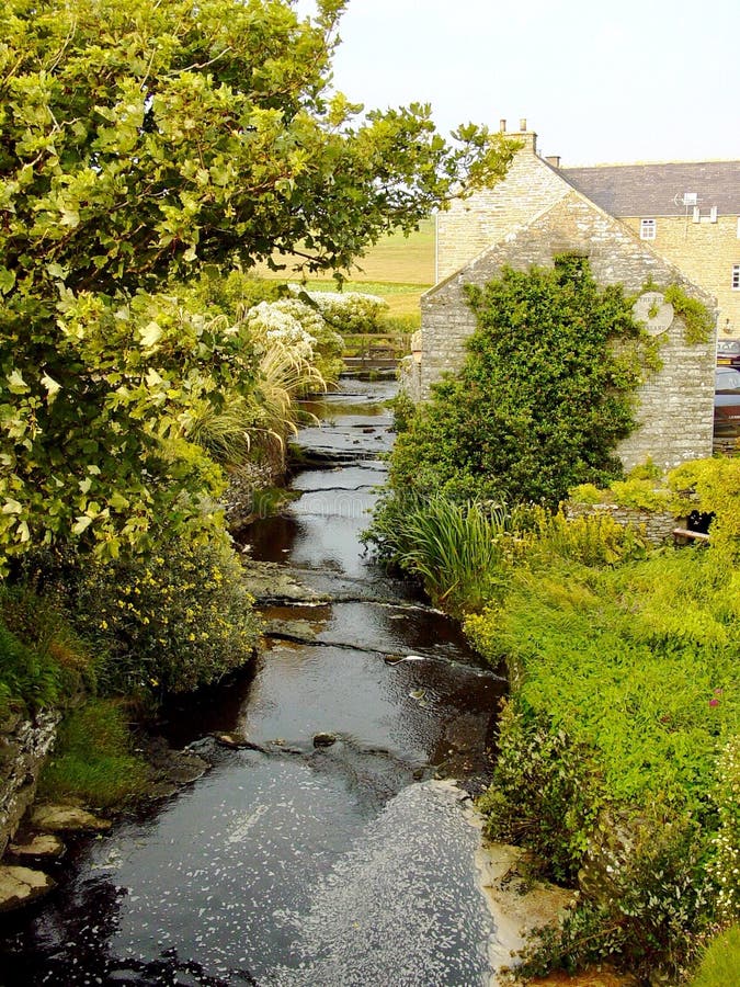 Old Mill And Stream. Times Gone By. Picturesque Stone Buildings. Stock