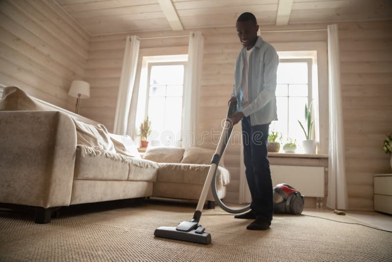 African American man use vacuum cleaner hovering house royalty free stock photo African American man use vacuum cleaner hovering house royalty free stock photo