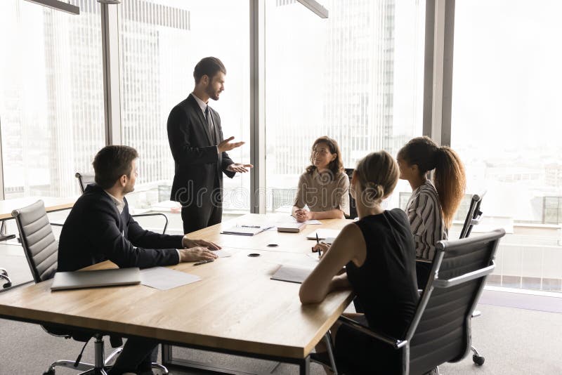 Millennial European businessman in suit lead formal meeting stock image